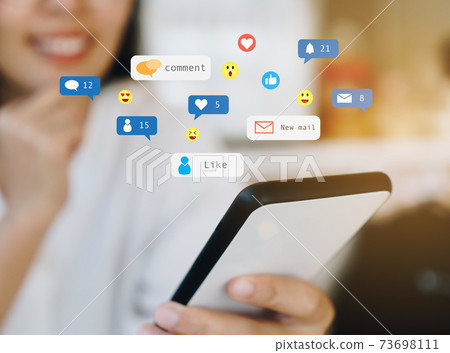 Woman happy play social media on smartphone with communication icon. Technology concept. Woman happy play social media on smartphone with communication icon. Technology concept. 73698111