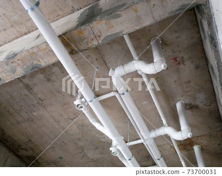 IPOH, MALAYSIA -JANUARY 2, 2021: Sewerage pipes form toilet above are interconnected under the floor soffit. Installed in gradient and gravity flow. Channeled to the main sewer line. IPOH, MALAYSIA -JANUARY 2, 2021: Sewerage pipes form toilet above are interconnected under the floor soffit. Installed in gradient and gravity flow. Channeled to the main sewer line. 73700031