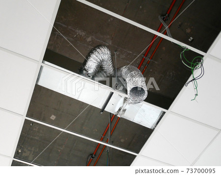 KUALA LUMPUR, MALAYSIA -JULY 24 2020: The suspended ceiling, electrical wiring, cabling and mechanical equipment under installation. It is hanging at the floor soffit. Cover by ceiling board. KUALA LUMPUR, MALAYSIA -JULY 24 2020: The suspended ceiling, electrical wiring, cabling and mechanical equipment under installation. It is hanging at the floor soffit. Cover by ceiling board. 73700095