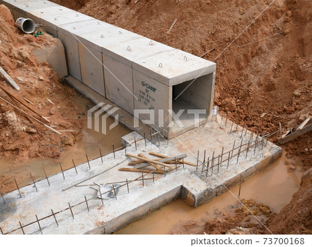 SELANGOR, MALAYSIA -JANUARY 19, 2020: Underground precast concrete box culvert drain under construction at the construction site. It is used to channel stormwater to the nearest monsoon drain. SELANGOR, MALAYSIA -JANUARY 19, 2020: Underground precast concrete box culvert drain under construction at the construction site. It is used to channel stormwater to the nearest monsoon drain. 73700168