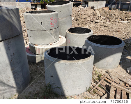 KUALA LUMPUR, MALAYSIA  -MARCH 2, 2020:  Circular shape precast concrete manhole stacked at the construction site.  73700216
