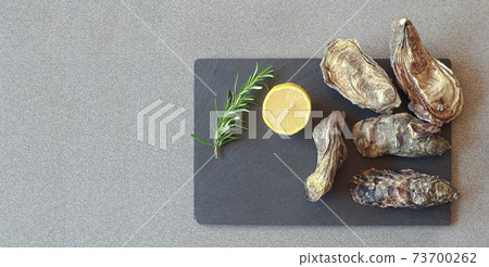 Fresh oysters on a slate board Fresh oysters on a slate board 73700262