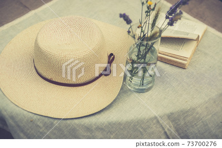 A women summer hat on a table A women summer hat on a table 73700276