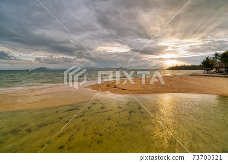 White sand beach in Phayam Island at sunset, Ranong, Thailand. 73700521