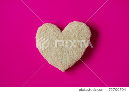 Heart-shaped slice of bread. 73700704