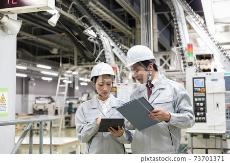 People working in the factory Confidential area image People working in the factory Confidential area image 73701371