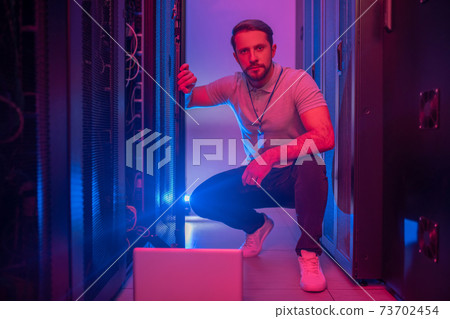 Confident young male administrator near workstation 73702454