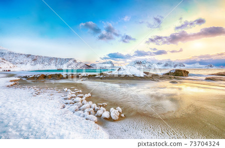 Fabulous winter scenery with Haukland beach during sunset and snowy  mountain peaks near Leknes. 73704324