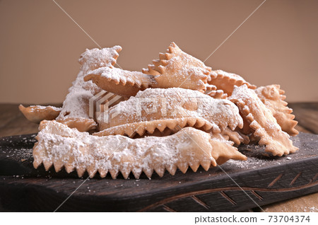 Italian Carnival and TYPICAL food. Sfrappole or chiachiere or angel wings and aromatic coffee on a 73704374