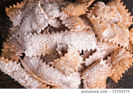 Italian Carnival and TYPICAL food. Sfrappole or chiachiere or angel wings and aromatic coffee on a 73704375