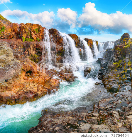 Majestic Kolufossar waterfall at summer sunny day. Majestic Kolufossar waterfall at summer sunny day. 73704494