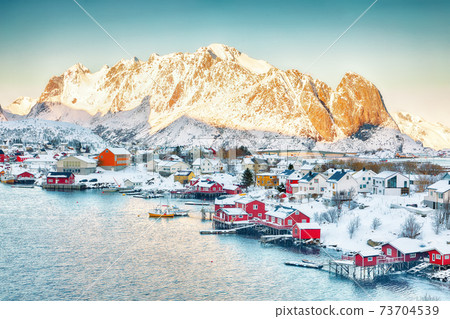 Dramatic evening cityscape of Reine town 73704539