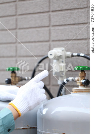 Workers inspecting propane gas cylinders Workers inspecting propane gas cylinders 73704930