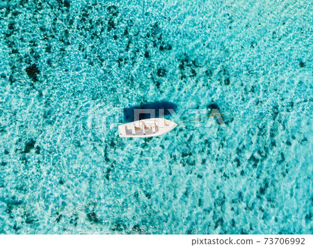 White boat in blue ocean in paradise island. Aerial view. 73706992