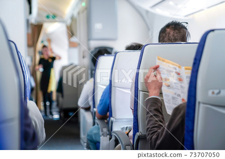 somebody read the menu in the plane, ready order to air hostess. 73707050