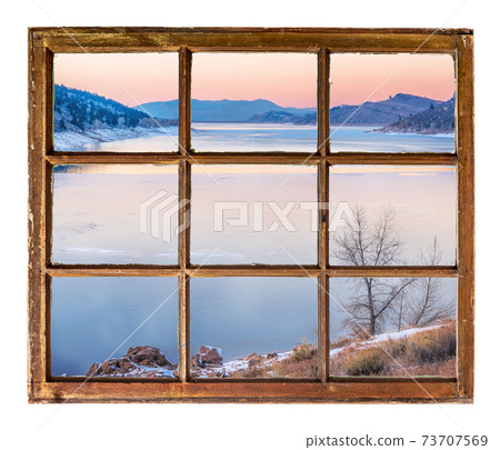 dusk over mountain lake in winter 73707569