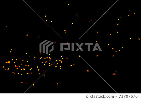 Particles of burning embers fly and glow isolated in the night sky. Natural yellow-hot sparks of fire on a black background, bright yellow bokeh from the fire. Particles of burning embers fly and glow isolated in the night sky. Natural yellow-hot sparks of fire on a black background, bright yellow bokeh from the fire. 73707676
