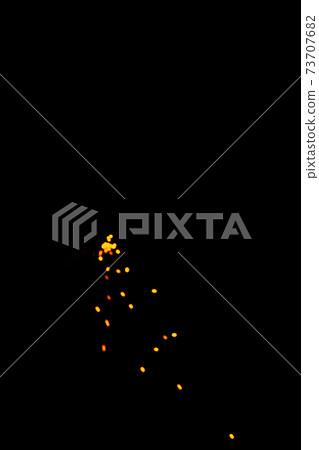 Particles of burning embers fly and glow isolated in the night sky. Blurred bright sparks on black background, yellow hot blurred lights on dark background. Particles of burning embers fly and glow isolated in the night sky. Blurred bright sparks on black background, yellow hot blurred lights on dark background. 73707682