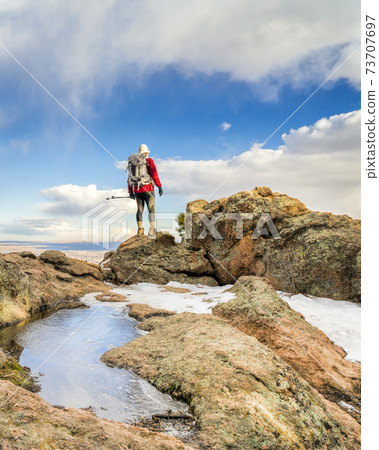 mature backpacker on a mountain ridge 73707697
