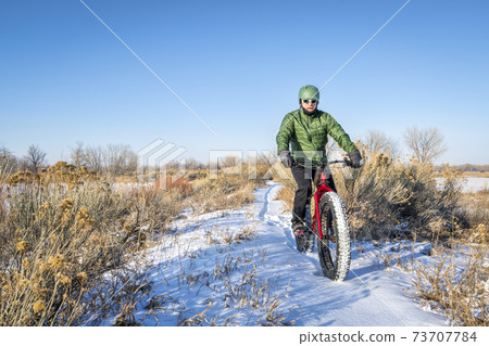 riding fat bike in winter 73707784