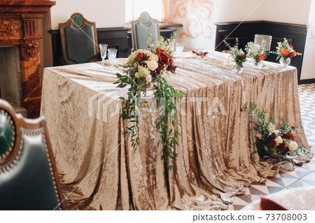 wedding table decoration with flowers on the table in the castle, table decor for dinner by candlelight.Dinner with candles 73708003