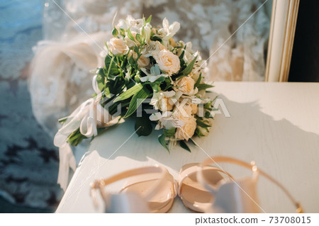 wedding bouquet with roses on the table.The decor at the wedding 73708015