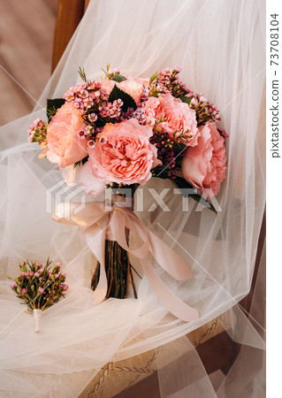 wedding bouquet with roses and boutonniere.The decor at the wedding 73708104