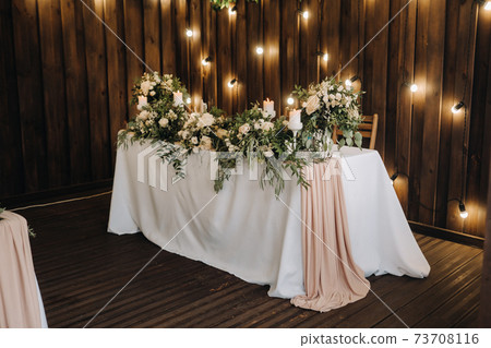 wedding table decoration with flowers on the table in the castle, table decor for dinner by candlelight.Dinner with candles 73708116
