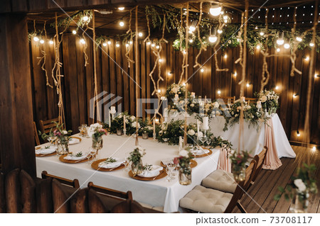 wedding table decoration with flowers on the table in the castle, table decor for dinner by candlelight.Dinner with candles 73708117