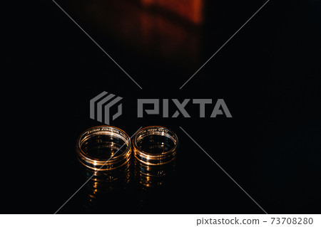 Close-up of two gold wedding rings for a wedding 73708280