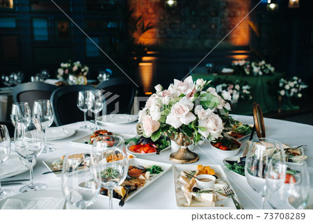 wedding table decoration with flowers on the table in the castle, table decor for dinner by candlelight.Dinner with candles 73708289