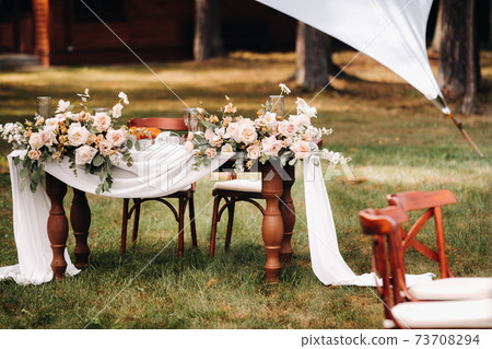 wedding table decoration with flowers on the table in the castle, table decor for dinner by candlelight.Dinner with candles 73708294