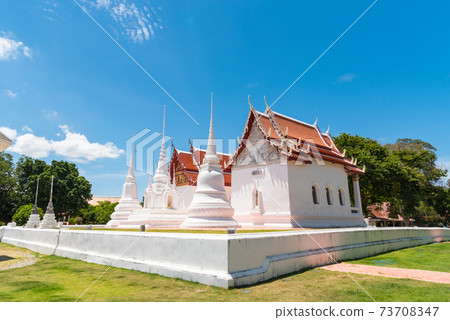 three white pagoda and chapel in Wat Uposatharam, old temple in Uthai thani province, Thailand 73708347