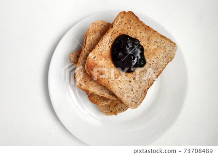 Crispy longing with chocolate for breakfast, toast and chocolate on a white plate. Crispy longing with chocolate for breakfast, toast and chocolate on a white plate. 73708489