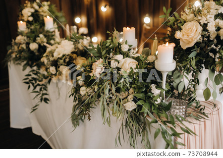 wedding table decoration with flowers on the table, candlelit dinner table decor. 73708944