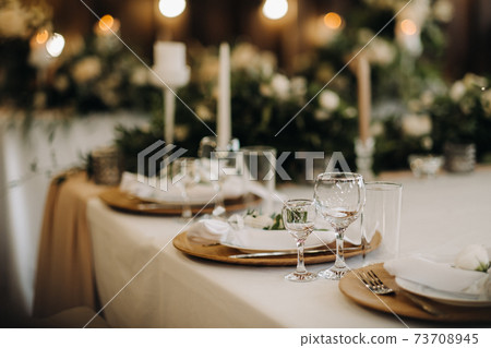 wedding table decoration with flowers on the table, candlelit dinner table decor. 73708945