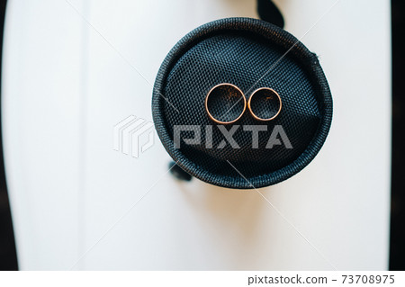 Close-up of two gold wedding rings for a wedding 73708975