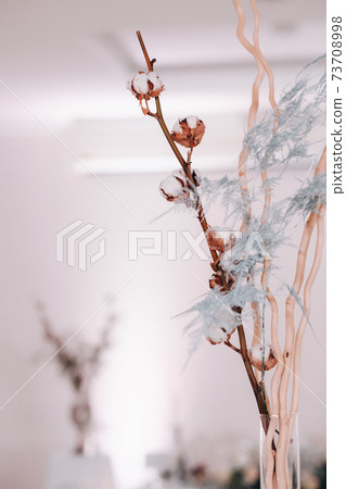 decoration with fluffy flowers on the table in winter style at the wedding 73708998