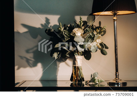 wedding bouquet with roses and boutonniere.The decor at the wedding 73709001