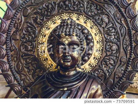Closeup Tailand buddhism statue: bust Buddha monument with ornament circle background in temple Closeup Tailand buddhism statue: bust Buddha monument with ornament circle background in temple 73709591