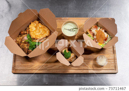 top view of kraft paper food containers with meal for delivery 73711467