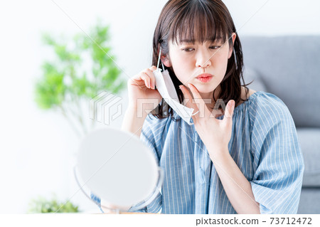 A woman suffering from rough skin due to a mask 73712472