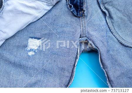 Inside of jeans on blue background. Inside of jeans on blue background. 73713127