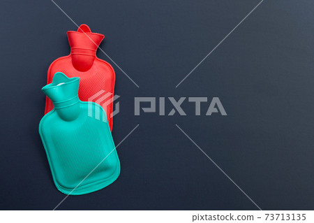 Hot water bags on dark background. Hot water bags on dark background. 73713135