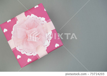 在灰色的背景上的粉紅色禮品盒 73714203