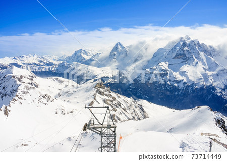 Stunning panoramic view of the Swiss Alps from the top of the Schilthorn mountain in the Jungfrau region of the country Stunning panoramic view of the Swiss Alps from the top of the Schilthorn mountain in the Jungfrau region of the country 73714449