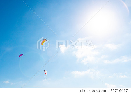 Bara glider and sun flying in the blue summer sky Bara glider and sun flying in the blue summer sky 73716467