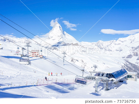 Skier in Cable car to Matterhorn Glacier Paradise with cloudy blue sky in cold summer day at Zermatt, Switzerland 73716750