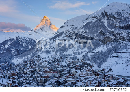Beautiful view of old village in twilight time with Matterhorn peak background in Zermatt, Switzerland. 73716752
