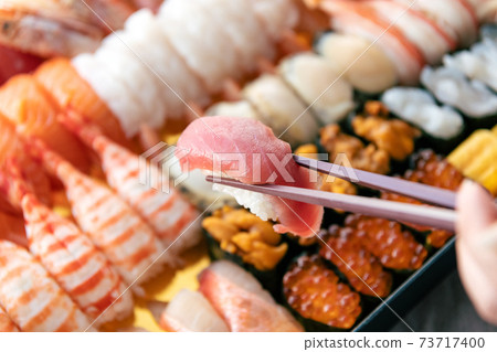 A lot of sushi packed in a tub 73717400